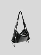 Small black Willow Bag 45 degrees on a plain grey background