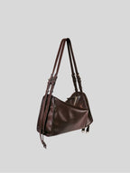 Small brown Willow Bag 45 degrees on a plain grey background