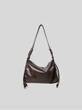 Small top-grain brown Willow Bag on a plain grey background