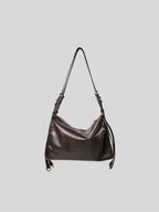 Small top-grain brown Willow Bag on a plain grey background