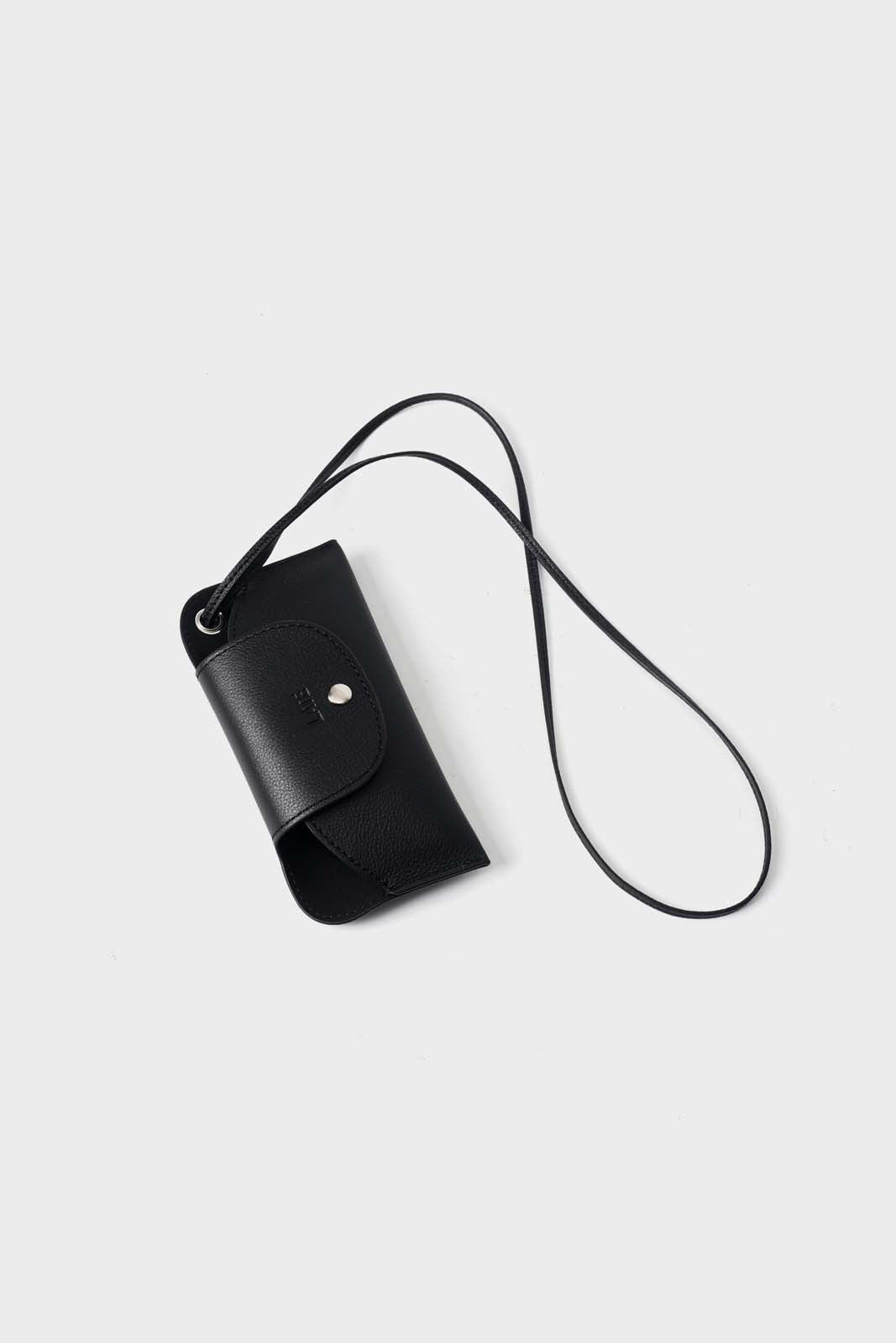 Black leather sunglasses pouch with a strap on a light gray background