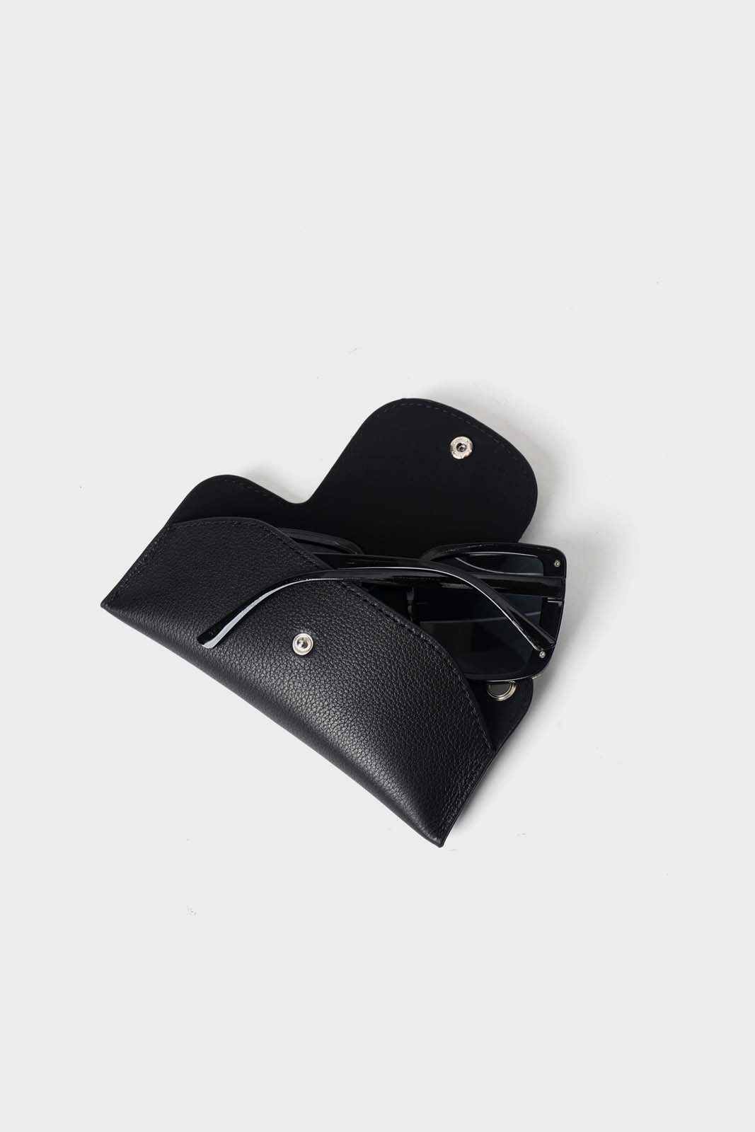 Black leather glasses case with black sunglasses inside