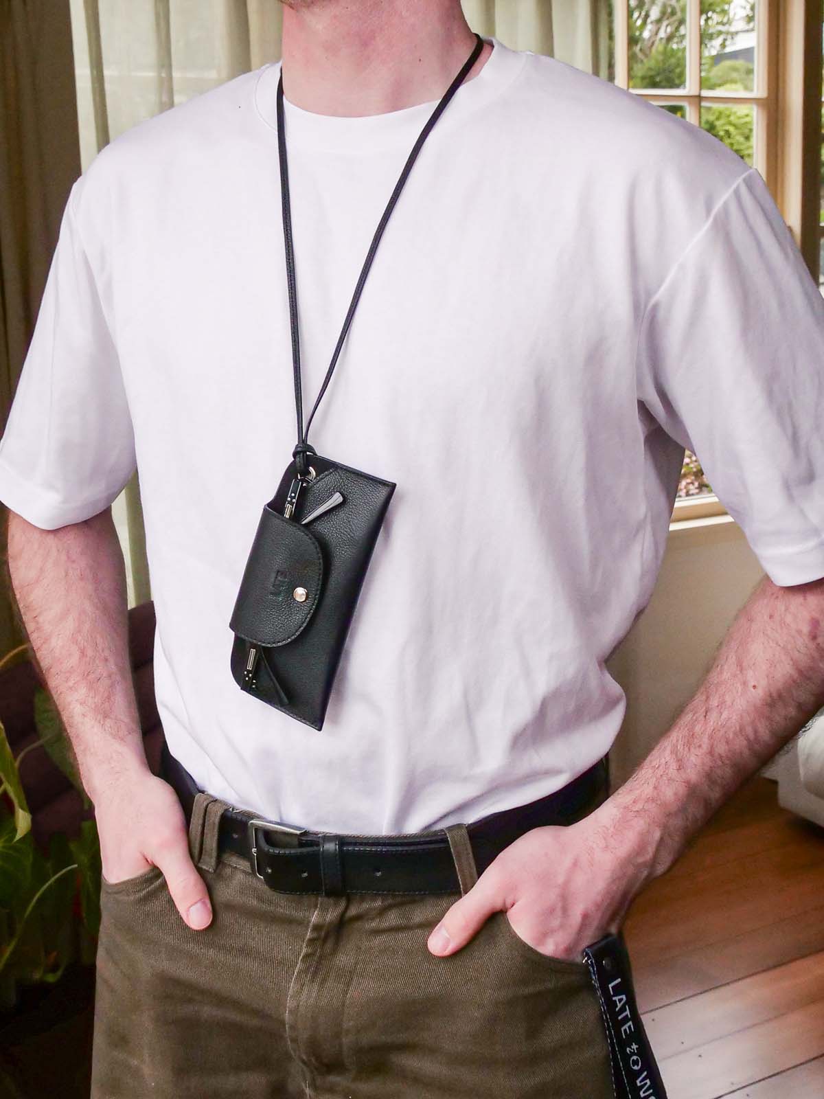 Person wearing the Late to Work sunglasses case around their neck