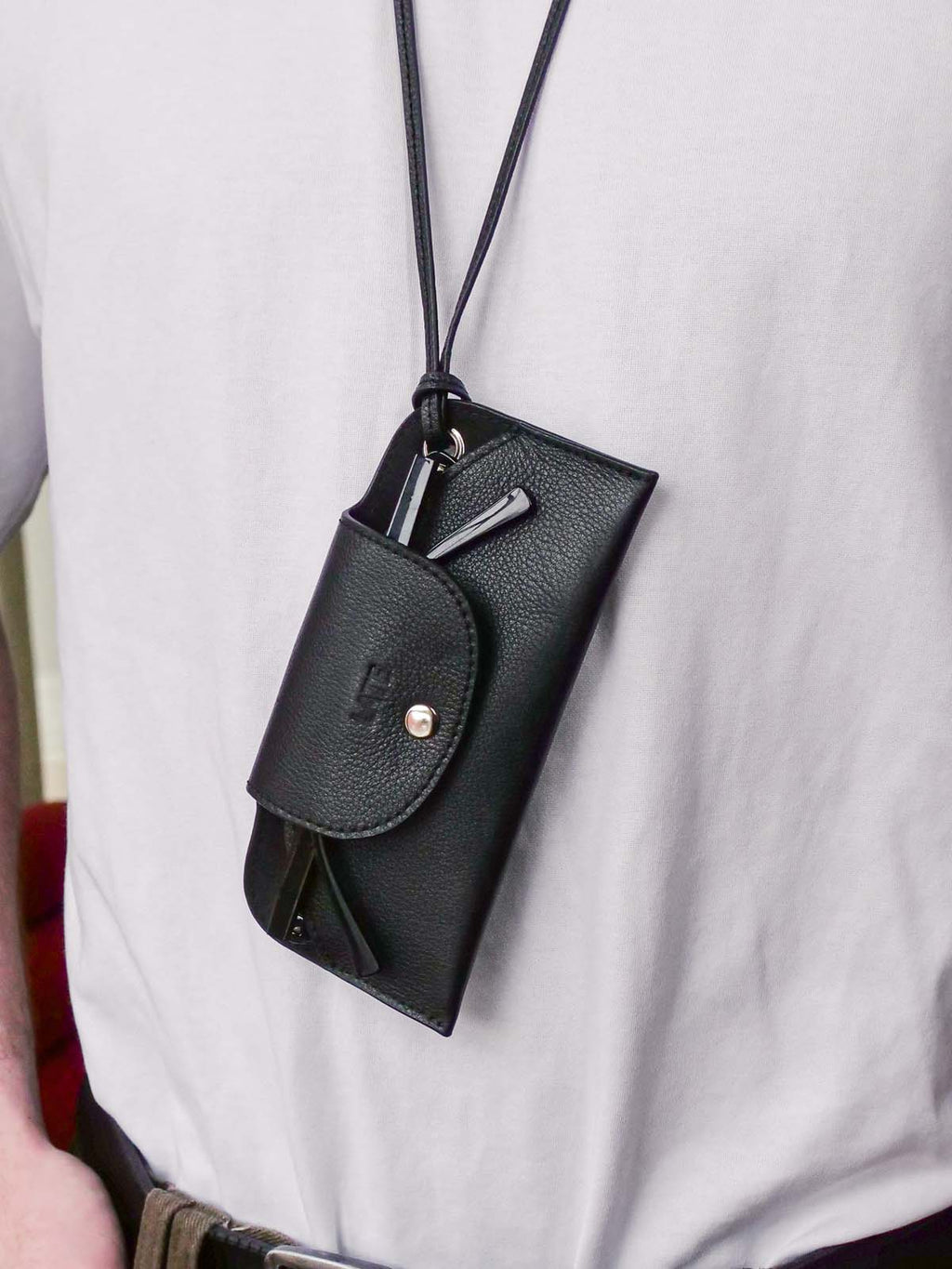 Close up of sunglasses pouch worn on a persons neck