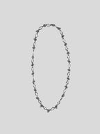 Varna  stainless steel necklace on plain background