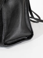 Black Willow Bag close up of embossed 'Late to Work' leather on side of bag