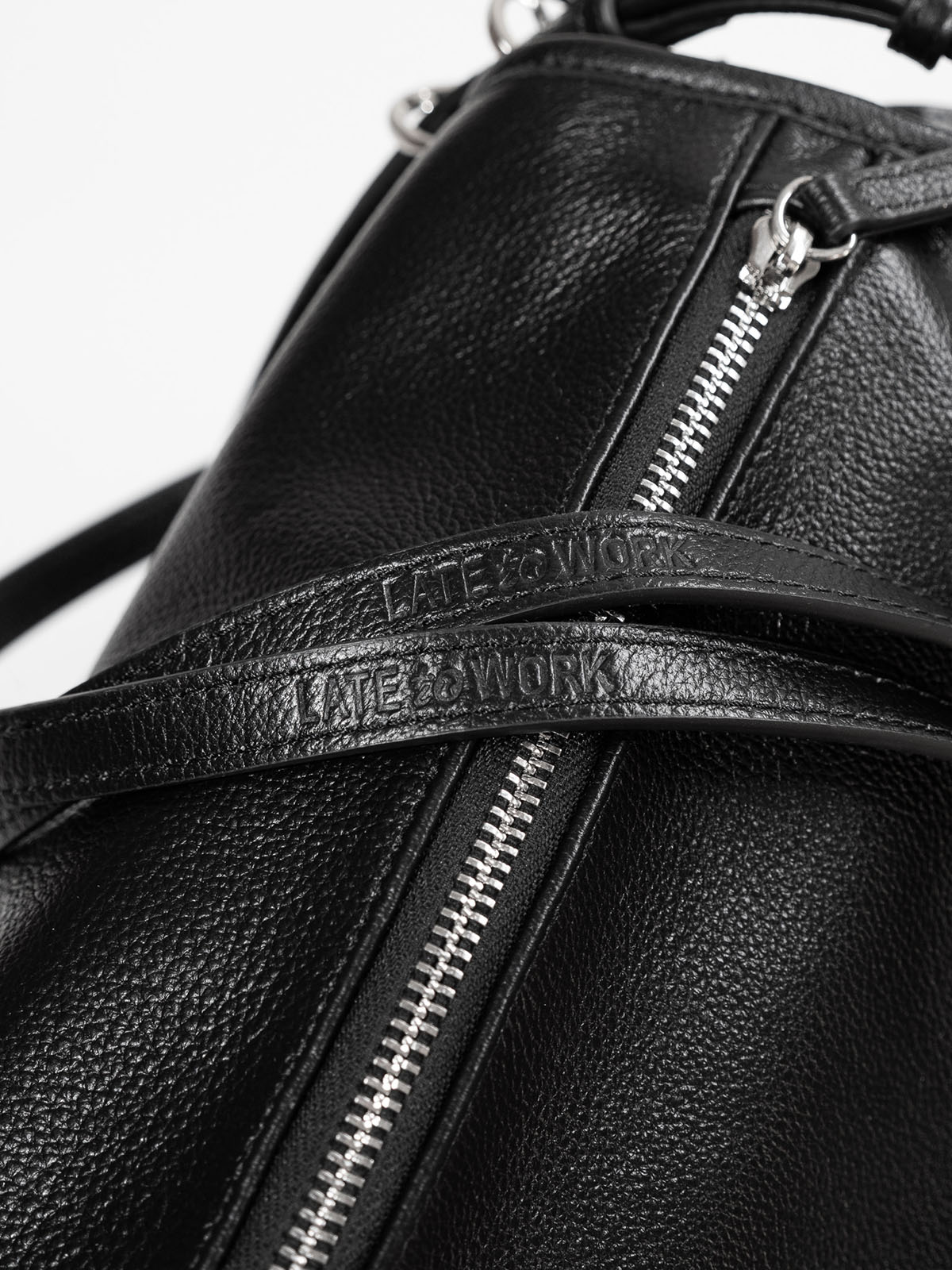 Close up of 'Late to Work' embossed on Willow Bag's double straps