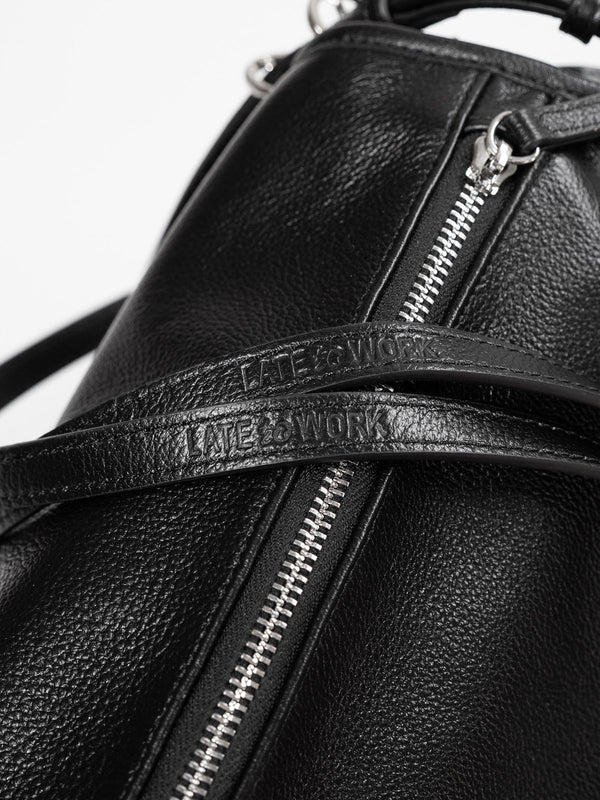Close up of 'Late to Work' embossed on Willow Bag's double straps