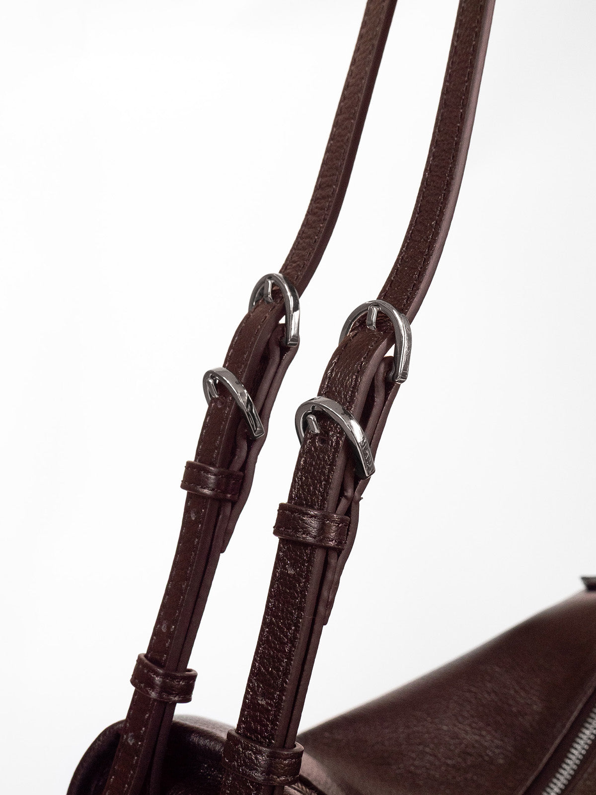 Brown Willow Bag close up of double straps featuring quadruple silver buckle hardware 