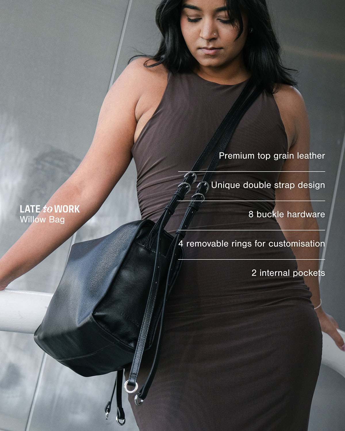 Woman carrying black Willow Bag with product features listed on the screen: premium top-grain leather, unique double strap design, 8 buckle hardware, 4 removable rings and 2 internal pockets