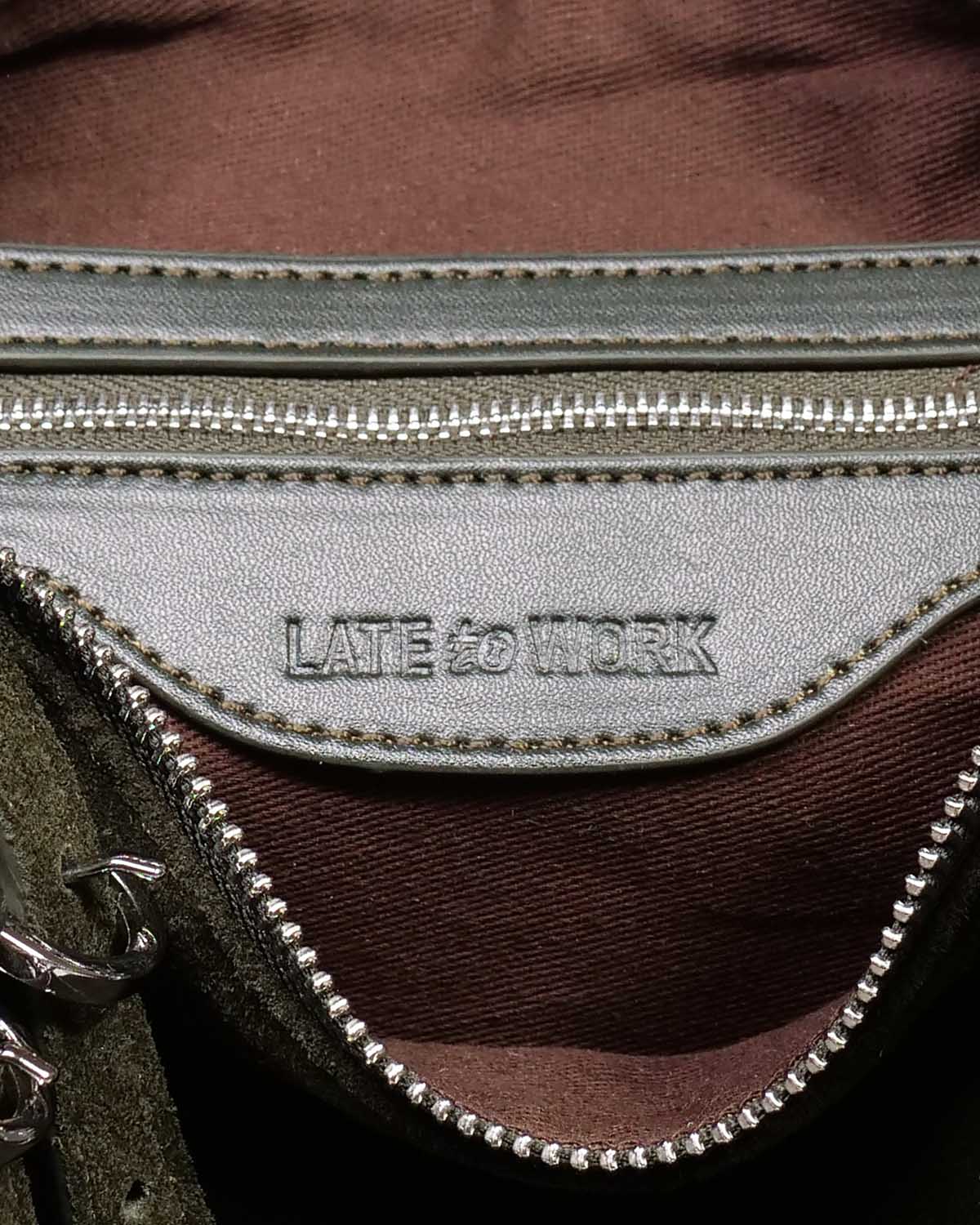 Close up of interior zipped pocket with 'Late to Work' embossed inside